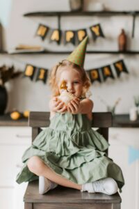 Enfant célébrant son anniversaire avec un cupcake et une bougie chiffre 4, décoration d’anniversaire enfant joyeuse.